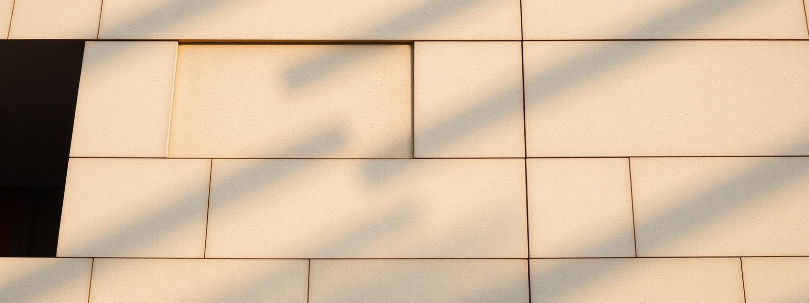 Concrete facade detail with soft raking shadows